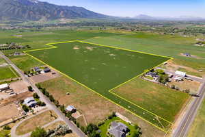 Aerial view of sparsely populated area featuring a mountain backdrop and property boundaries highlighted