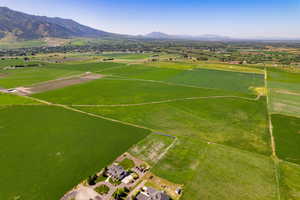 Aerial view of sparsely populated area with a mountainous background and farmland