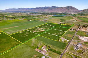 Aerial overview of property's location with property boundaries highlighted and a water and mountain view