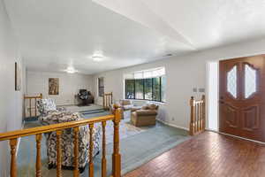 Carpeted entrance foyer with a textured ceiling