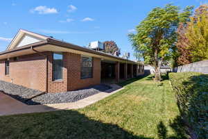 Back of house with a patio and brick siding