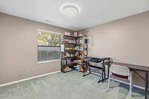 Office featuring light colored carpet and baseboards