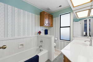 Bathroom with a garden tub, ornamental molding, vanity, and light tile patterned floors