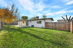 Back of house featuring a fenced backyard and a patio