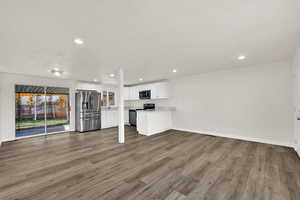 Unfurnished living room featuring light wood-style floors, recessed lighting, and a textured ceiling