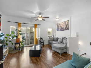 Living area featuring wood finished floors and ceiling fan