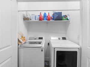 Washroom featuring washer and dryer
