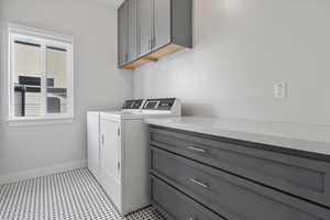 Laundry room featuring washer and dryer and cabinet space
