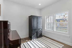 Bedroom with dark wood-style floors and recessed lighting