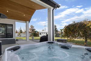 View of patio with a hot tub