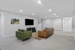 Living area with carpet flooring and recessed lighting