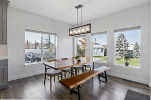 Dining space with dark wood-style flooring