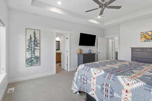 Bedroom with a raised ceiling, carpet, a ceiling fan, and recessed lighting
