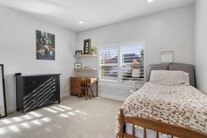 Bedroom with light carpet and recessed lighting