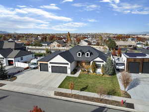 View of front facade featuring a residential view, driveway, and a garage