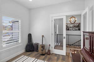 Misc room with a chandelier, dark wood-style flooring, plenty of natural light, and recessed lighting