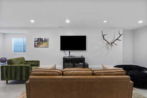 Living area with carpet floors and recessed lighting