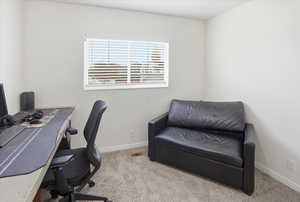 Office featuring light colored carpet and baseboards