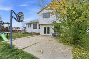Rear view of house featuring a trampoline and a patio area