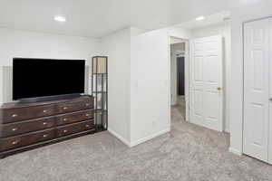 Bedroom featuring light carpet and recessed lighting