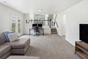 Carpeted office space with baseboards