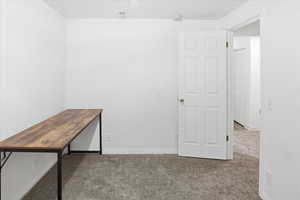 Unfurnished office featuring carpet and baseboards