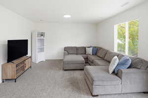Living area featuring carpet floors and baseboards
