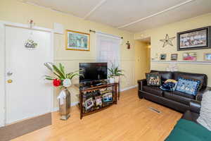 Living room featuring wood finished floors and baseboards