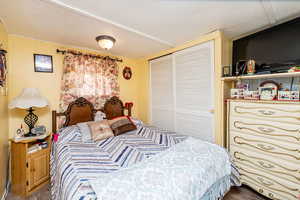 Bedroom with a closet and wood finished floors