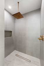 Bathroom featuring a tile shower