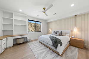 Bedroom featuring built in desk, a ceiling fan, light wood finished floors, and recessed lighting
