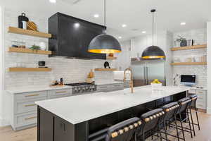 Kitchen with open shelves, backsplash, light wood-style flooring, and recessed lighting