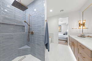 Ensuite bathroom featuring walk in shower, vanity, and recessed lighting