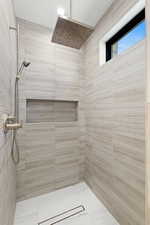 Full bath with a tile shower
