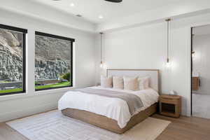 Bedroom with wood finished floors, recessed lighting, and a ceiling fan