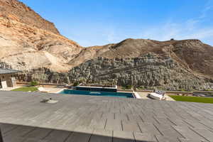 Outdoor pool with a patio and a mountain view