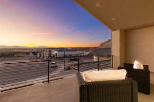 Balcony at dusk featuring a mountain view