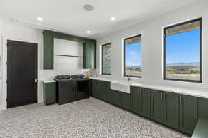 Laundry area featuring cabinet space, recessed lighting, a mountain view, and washing machine and clothes dryer