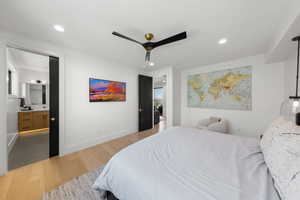 Bedroom featuring light wood-style flooring, recessed lighting, ensuite bathroom, and a ceiling fan
