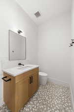 Bathroom featuring vanity and toilet