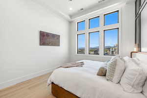 Bedroom featuring wood finished floors, a mountain view, and recessed lighting