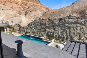 Outdoor pool with a patio and a mountain view