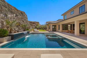 View of swimming pool featuring a patio and a pool with connected hot tub