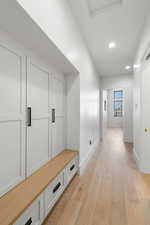 Mudroom featuring light wood finished floors and recessed lighting