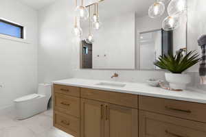 Full bath with vanity and light marble finish floors