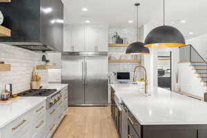 Kitchen with open shelves, appliances with stainless steel finishes, white cabinets, tasteful backsplash, and recessed lighting