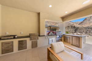 View of patio / terrace with area for grilling and a mountain view