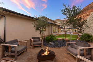 View of patio featuring a mountain view, a fire pit, and a swimming pool