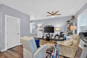 Living room featuring wood finished floors and ceiling fan