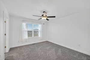 Carpeted spare room with baseboards